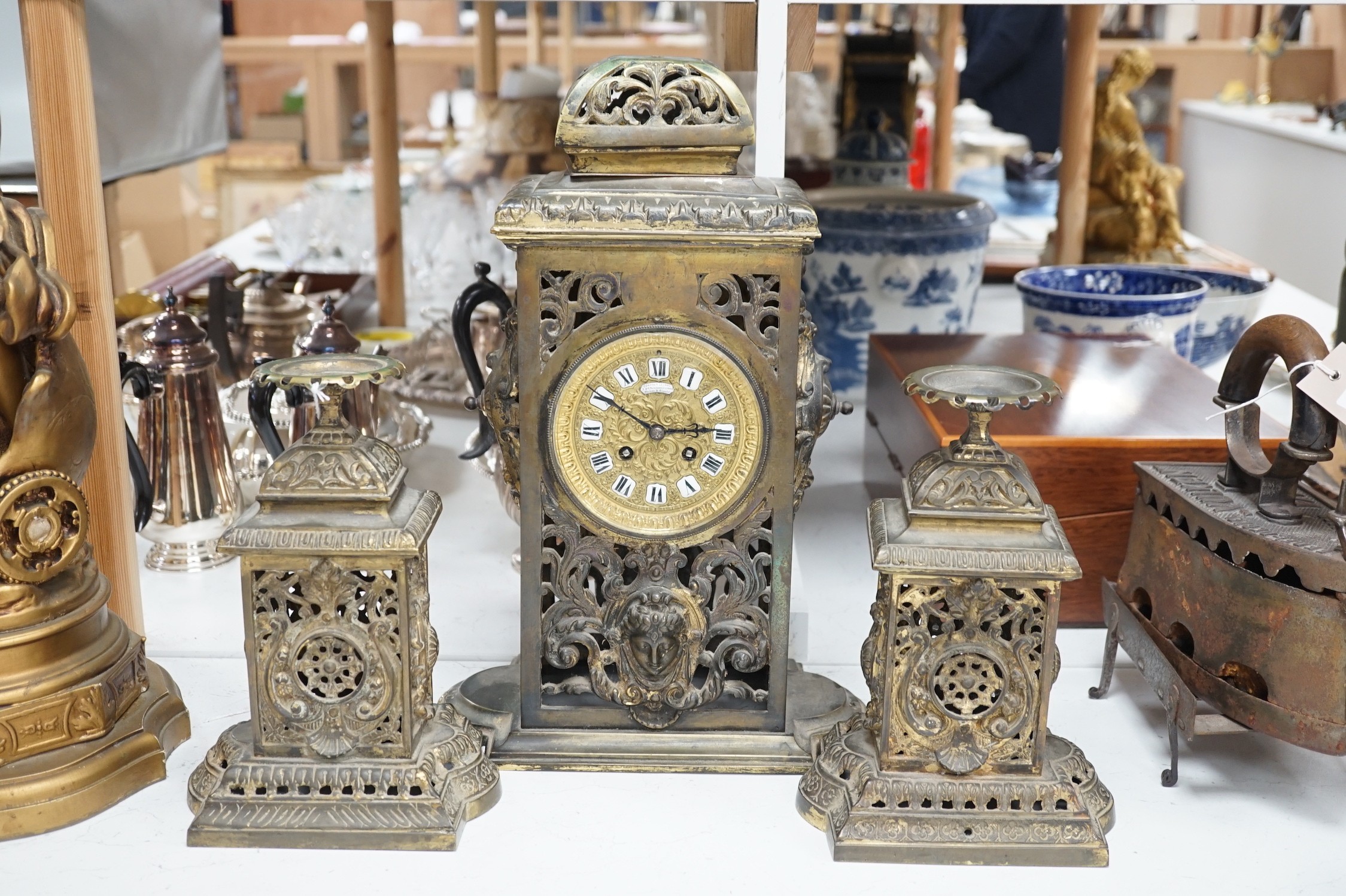 A French brass clock garniture, Comptoir General, 9 Bd Poissenniere, Paris, Maison H. Riondet on an enamel plaque to the dial. Height 42cm